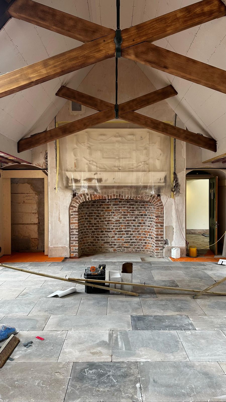The billiard room before the panelling, with the brick fireplace and plaster panel