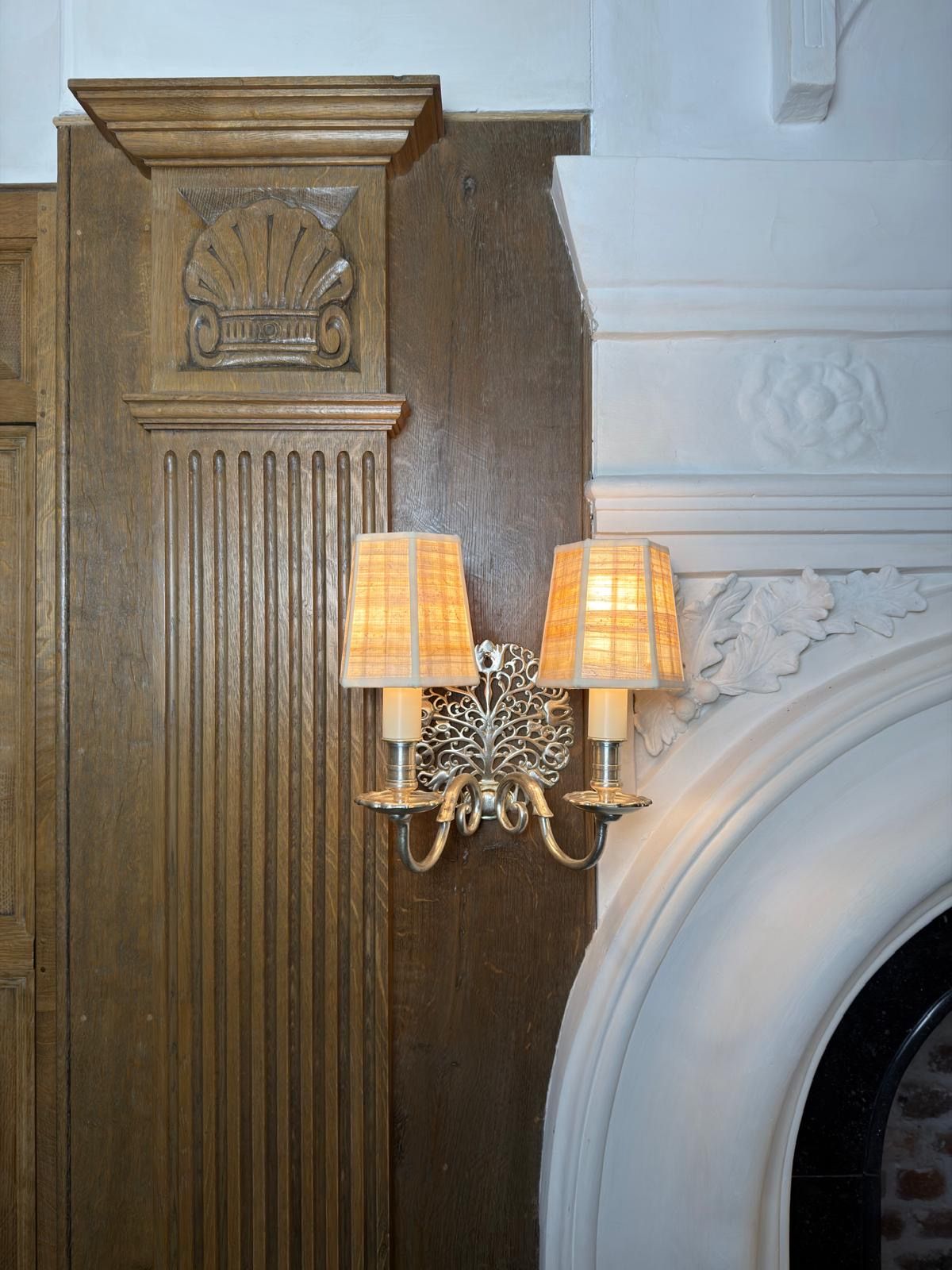 Oak pilasters with carved shell capitals beside the new plaster chimneypiece in the billiard room