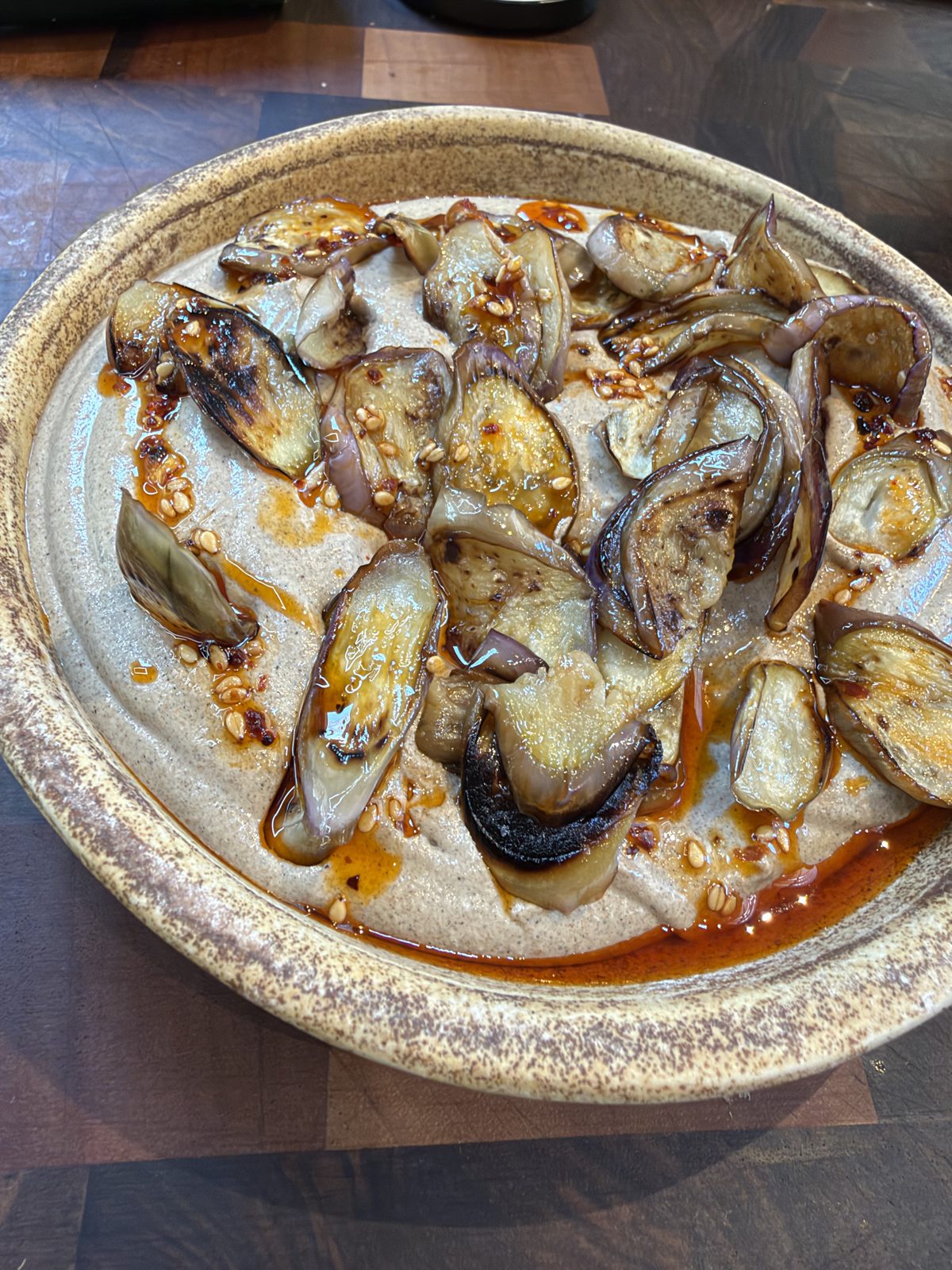 A dish of roasted aubergines with chilli oil