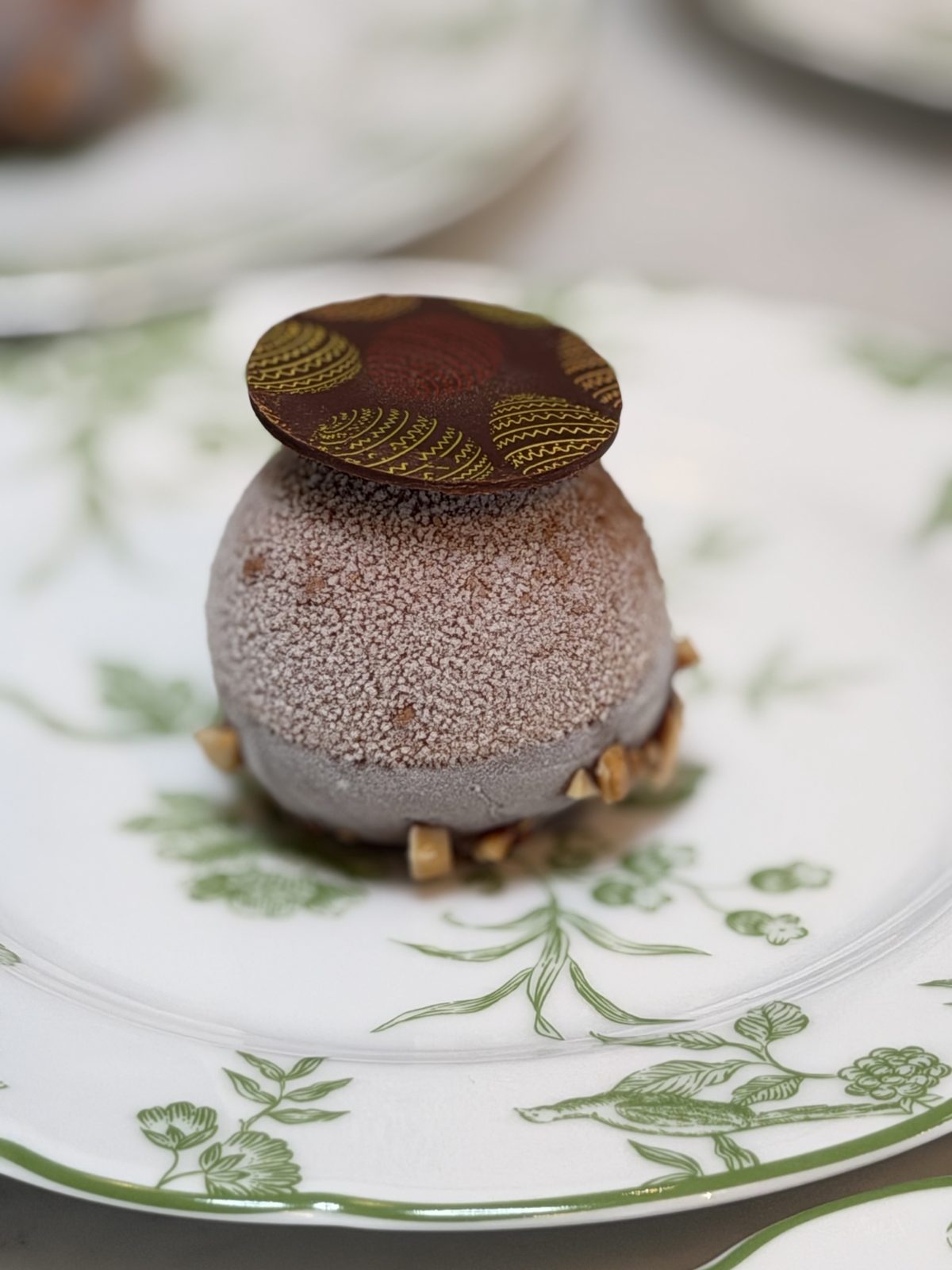 A chocolate pudding on a green-and-white plate