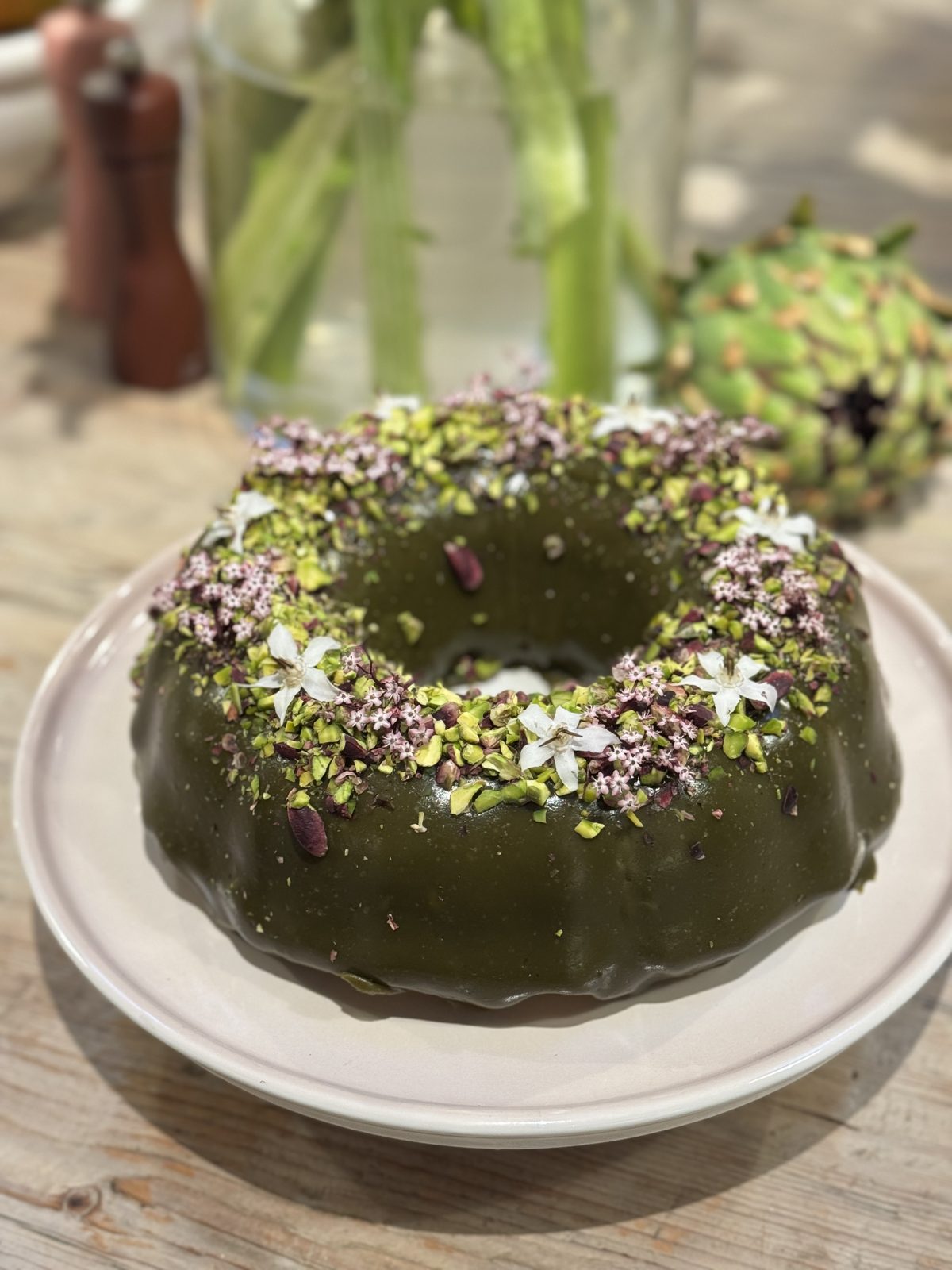 A green ring cake scattered with flowers