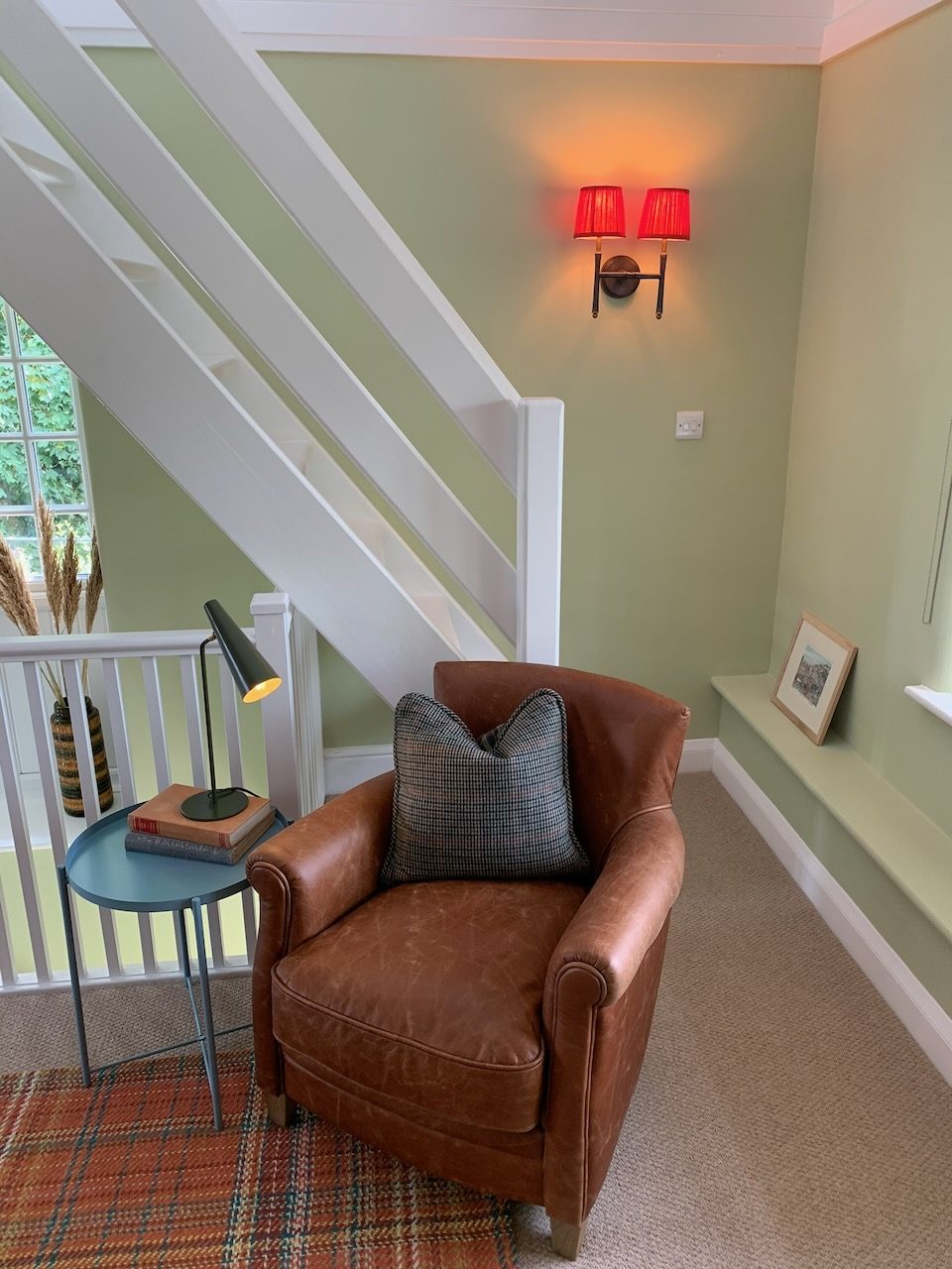 A leather armchair at the foot of the stairs