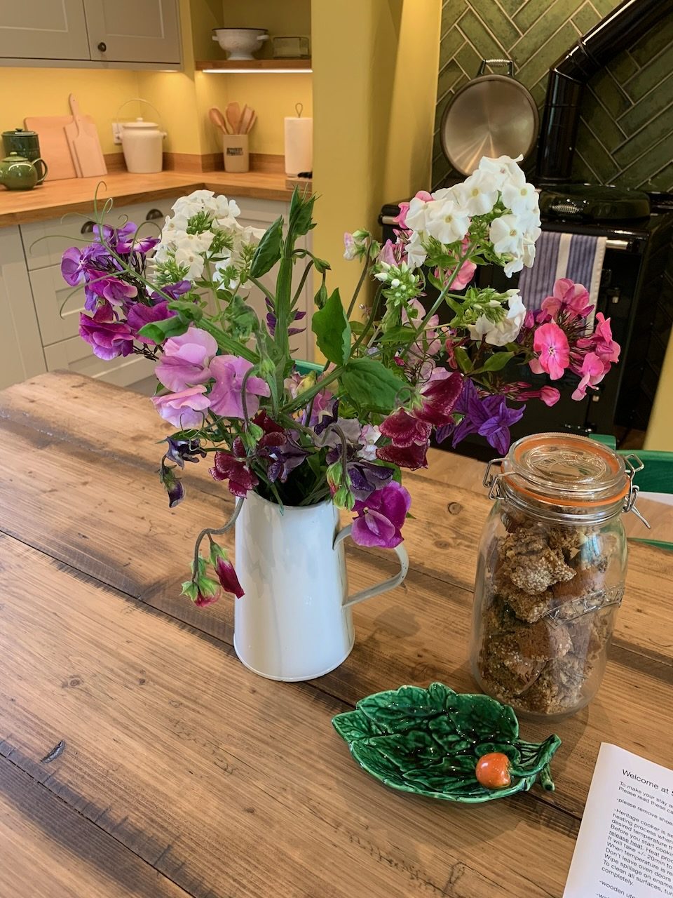 Sweet peas and phlox in a jug on the kitchen table