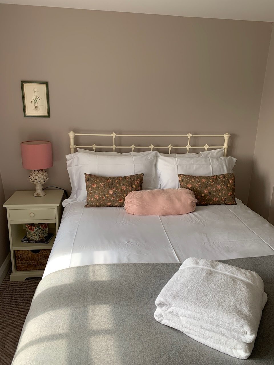 A double bedroom with an iron bedstead